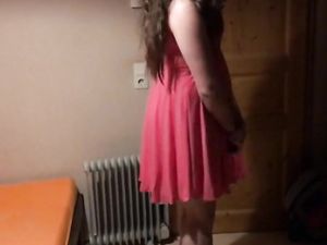 Sissy in pink dress strokes her cock with...